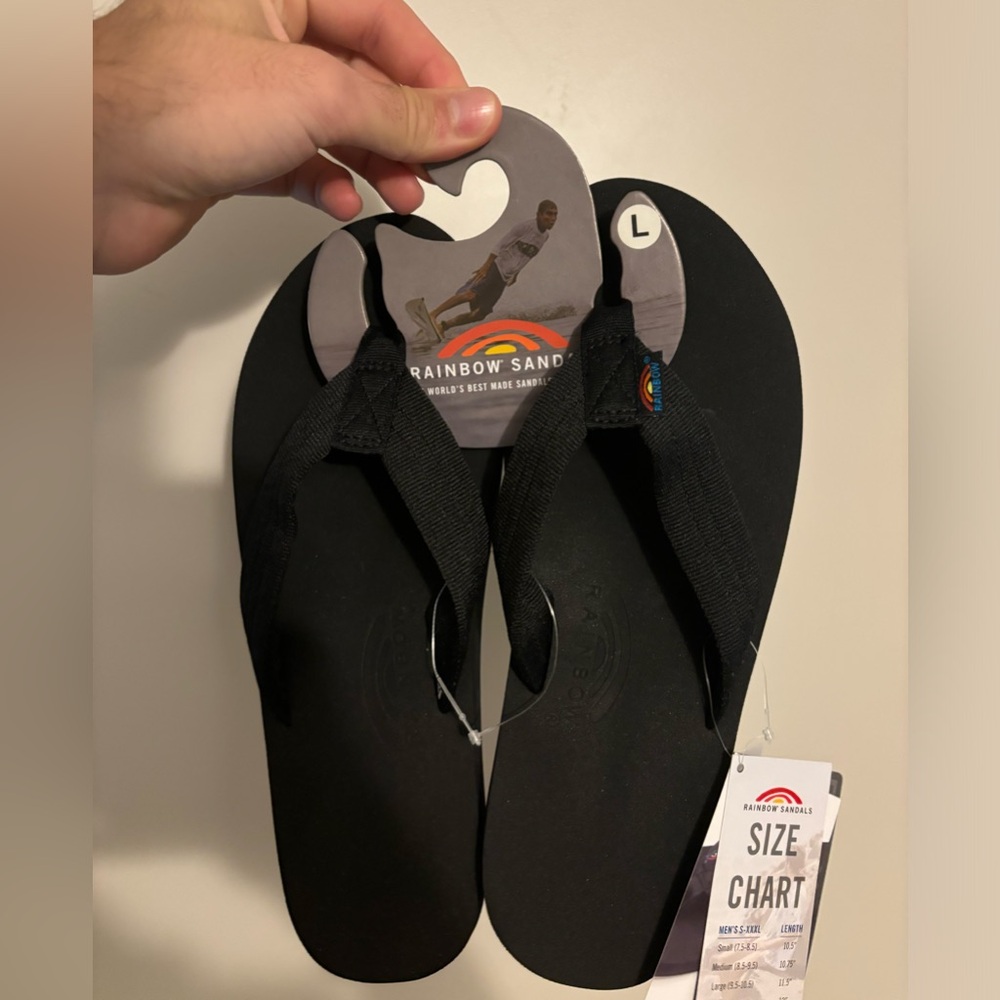 New black rainbow sandals with tags.